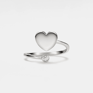 A gold-plated sterling silver ring featuring a heart-shaped design with a small cubic zirconia embellishment on the top.