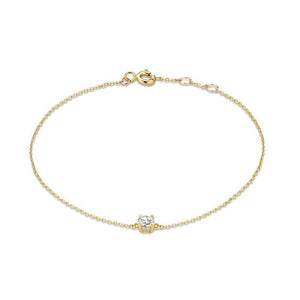 A gold-plated sterling silver bracelet with a heart charm, displayed on a person's wrist.