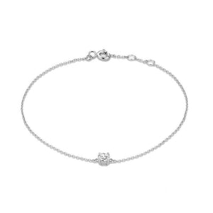 A gold-plated sterling silver bracelet with a heart charm, displayed on a person's wrist.