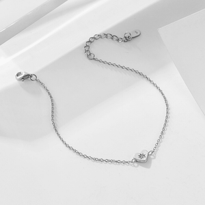 Silver bracelet with star-shaped charms on a white background