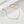 Gold bracelet with heart-shaped charms on a white surface