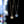 Two star-shaped pendants on gold and silver chains against a blurred colorful background
