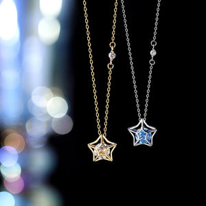Two star-shaped pendants on gold and silver chains against a blurred colorful background