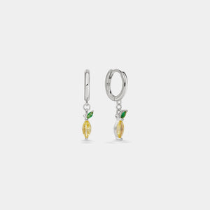 Pair of silver earrings with yellow and green accents on a light gray background