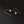Pair of gold and silver floral earrings on a black background