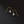 Pair of gold and silver floral earrings on a black background