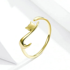 Gold cat-shaped ring on a light gray background