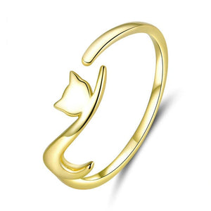 Gold cat-shaped open ring on a white background