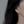Gold dragonfly earring worn by a person with dark hair.