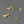 Gold dragonfly-shaped earrings on a gray background