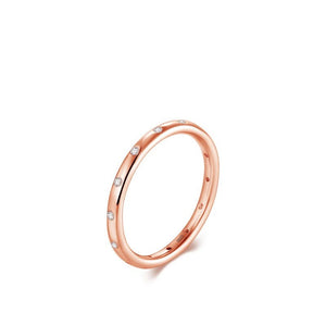 Rose gold ring with small diamonds on a white background