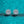 Snowflake-shaped silver earrings on a teal glittery background
