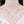 Silver necklace with small crystals on a mannequin with a white background