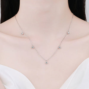 Silver necklace with small crystals on a mannequin with a white background