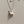 Two whale charm necklaces, one plated in silver and the other in gold, displayed against a neutral background.