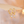 Gold hoop earrings with opalite stones on a soft background
