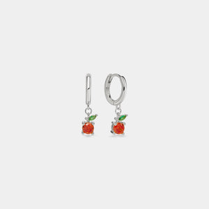Silver earrings with red fruit-like charms on a white background