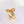 Gold butterfly ring with a yellow gemstone on a light background