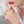 Close-up of a hand wearing a gold ring with a butterfly design, against a neutral background.