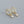 Gold hoop earrings with pearl drops on a gray background