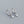 Silver hoop earrings with round gemstones on a gray background
