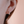 Pearl earring worn on an ear with a soft background