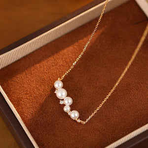Pearl necklace on a brown textured surface