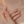 Pearl necklace being held by a hand against a soft background