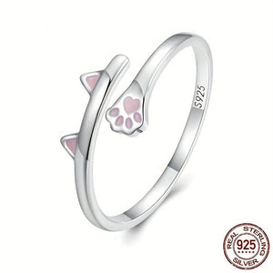 A dainty silver bypass ring featuring pink cat paw prints on the bypass part of the ring, marked with '925 Sterling Silver' and '925'.