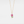 Gold necklace with a pink flower pendant on a white background