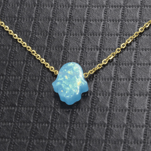 Necklace with a blue opal pendant on a textured gray background