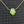 Neon green opal hamsa pendant on a gold chain against a dark textured background