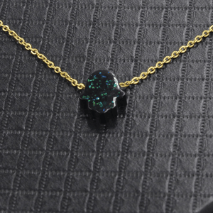Necklace with a black stone pendant on a textured gray background