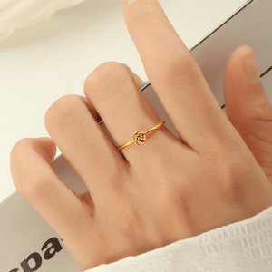 Gold ring on a finger with a blurred background