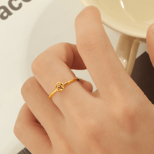 Gold ring on a finger with a blurred background