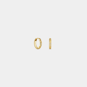 Gold hoop earrings on a light gray background