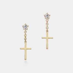 Gold cross earrings with star-shaped top elements on a light gray background