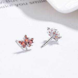 Silver earrings with red gemstones on a white background