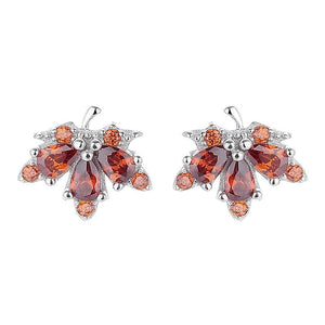 Pair of earrings with orange gemstones on a white background