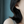 Close-up of a person wearing a silver hoop earring with a blurred background