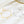 Gold and silver star-themed bracelets on a white surface with a crystal dish in the background.