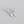 Silver hoop earrings with diamond-shaped pendants on a gray background
