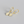 Gold hoop earrings with diamond-shaped charms on a gray background