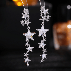 Star-shaped earrings on a dark background