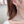 Star-shaped earrings worn by a person with a neutral background
