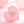 Silver star-shaped necklace on a pink stone with a soft pink background