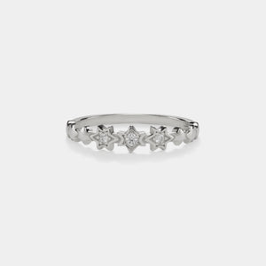 Silver ring with star-shaped diamonds on a white background