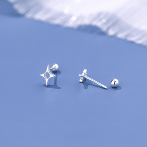 Silver star-shaped earrings on a light blue background