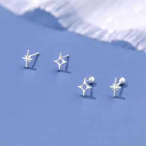 Silver star-shaped earrings on a blue background