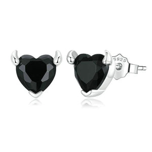 Heart-shaped black gemstone earrings with silver posts on a white background